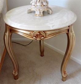 Marble top end table over wood gilt base with doe feet.