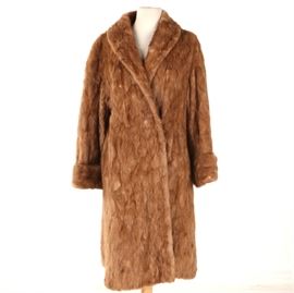 Vintage Kerrybrooke Mink Fur Coat: A vintage circa 1950s Kerrybrooke mink fur coat. The long coat offers a shawl collar, a hook and eye closure and cuffed sleeves. The interior is lined in a patterned russet colored textile with a label marked, “Sears, Roebuck and Co. U.S.A. Kerrybrooke is fashion”.