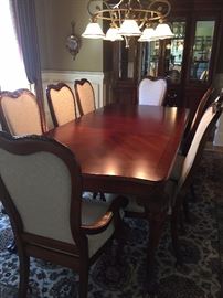Thomasville solid wood table with 8 chairs and 2 leaves and pads