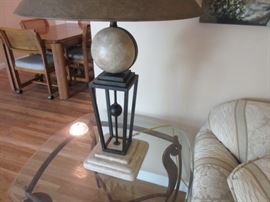 Elegant table lamp with rod iron and marble in the base on décor under the lamp shade.