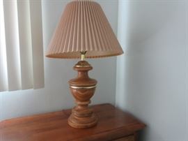Solid wood carved lamp base with shade.