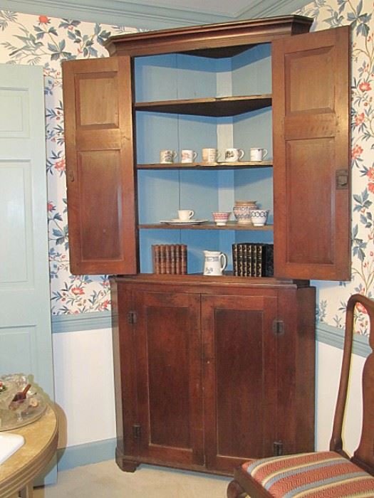 Moravian one piece walnut corner cupboard, circa 1810