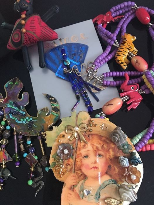 Many pieces of fun costume pins, necklaces and more.