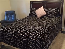 Queen Bed with Dark Wood Headboard.