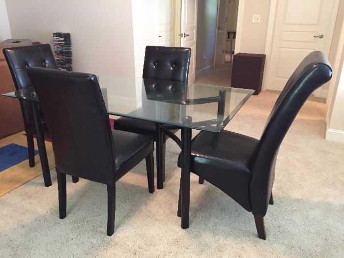 Glass and black chrome Dining Table with Four Faux leather chairs