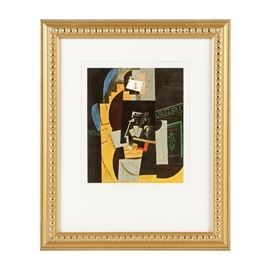 After Picasso Offset Lithograph on Paper "L'Homme aux cartes": An offset lithograph on paper after an oil painting titled L’Homme aux cartes (Card Player) by Pablo Picasso, originally created in 1914. This reproduction was created circa 1972. The image features Picasso’s synthetic Cubist style, with the appearance of fragmented objects and patterned paper scraps collaged together and abstractly suggestive of cards on a table. The print is presented in a gold-tone wood frame with a decorative relief pattern and a white mat.
