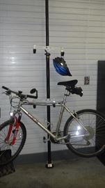 Motobecane bike on floor to ceiling bike holder (2 holders available, each holds 2 bikes)