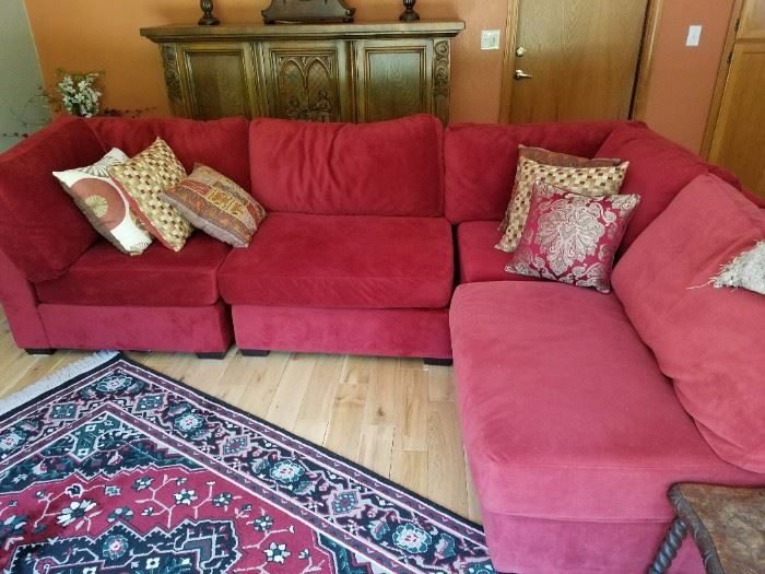 Comfortable Rusty/Red Sectional Sofa and Decorator Pillows. 