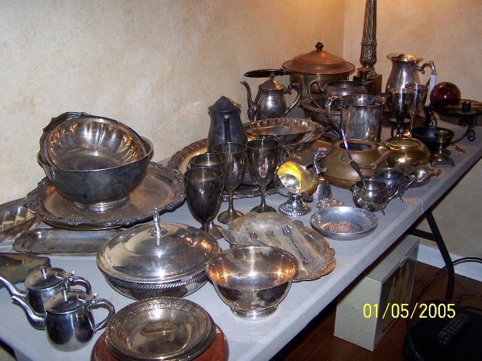 Table full of Silver plated pieces and 2 more full boxes under the table