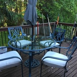 Round glass outdoor table with 4chairs with matching cushions and umbrella with stand