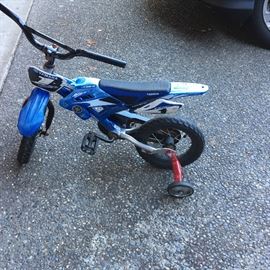  Small blue male child's bike with training wheels 