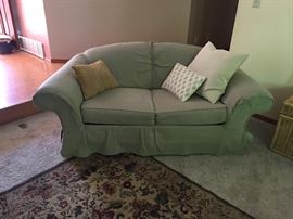 Matching sofa and loveseat in a pale green