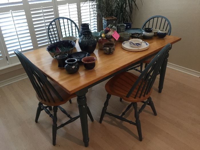 Very sturdy farm table with 4 chairs, lots of hand made signed pottery 