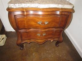 One of a pair of nightstands with marble tops