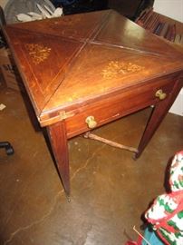 Game table.  The stretcher needs to be replaced, but the top has some beautiful details