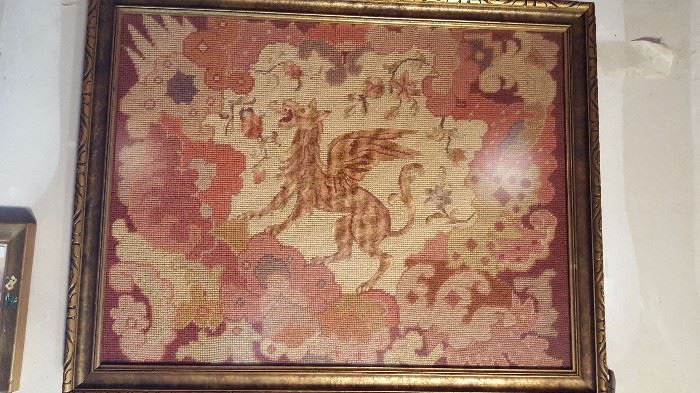 Framed tapestry of a Griffin.