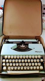 Vintage Olympia Turquoise Typewriter in black leather case.