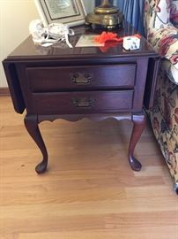 Solid cherry end table with drop leaves and drawers.