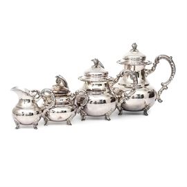 Sterling Silver Coffee Tea Service: An elegant sterling silver coffee and tea service. The five-piece set features a coffee pot, tea pot, lidded sugar bowl and creamer. The items are marked, “925, Sterling”. The carved footed pieces feature a scroll handle and rose finials. The coffee pot and tea pot lids are hinged to the side. Total weight inclusive of all materials is 59.700 ozt. Items are marked, “925, Sterling”. A coordinating oval tray is at item 17COL076-115.