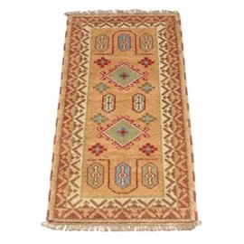 Hand-Knotted Indo-Caucasian Kazak Accent Runner Rug: A hand-knotted Indo-Caucasian Kazak accent runner rug. This small accent runner features two diamond shaped medallions in hues of dark sage green, olive green, rust and blue upon a dark sand toned patterned field. The field is encased by an arrowhead patterned compound border finished with brown and tan selvedge. The rug has natural warp fringe to either end and is unmarked.