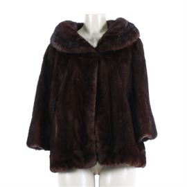 Vintage Classic Mahogany Mink Jacket by Morton Marks Furs: A vintage classic mahogany mink jacket by Morton Marks Furs. This mink jacket features a full shawl collar, two outer pockets, cropped sleeves and a single hook and eye closure.