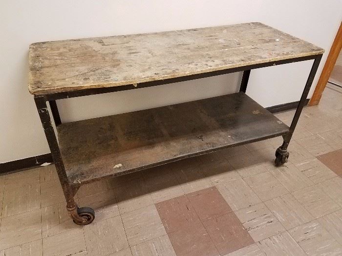 Steel and wood industrial/shop table (62x25x36). Steel lower shelf, wood upper shelf. Casters turn and roll well. 