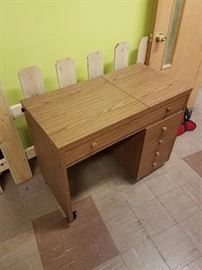 Grandma's sewing table. Has a removable cabinet and casters with brakes. 