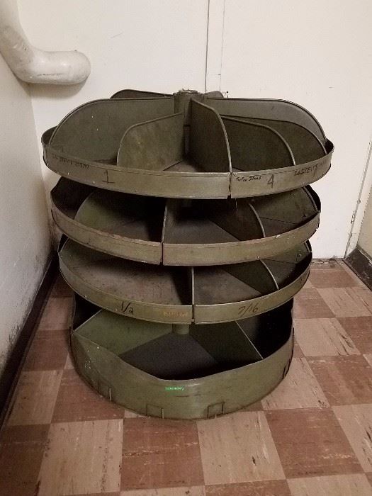 Old metal carousel parts bin. Was in a metal shop for decades. 35" diameter, 38" high, steel column base. Heavy, but comes apart. 