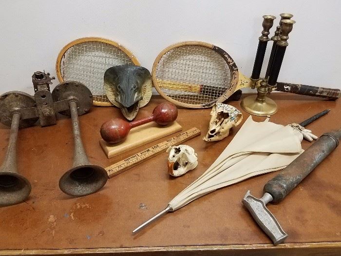 Double siren/air horn, northern pike (I think) taxidermy, beaver skull, another skull, parasol, grease gun and more