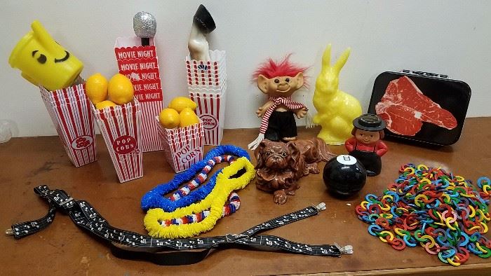 Kitsch pieces including music suspenders, a Magic 8 ball, wax bunny and popcorn bins. Also a novel steak lunchbox!