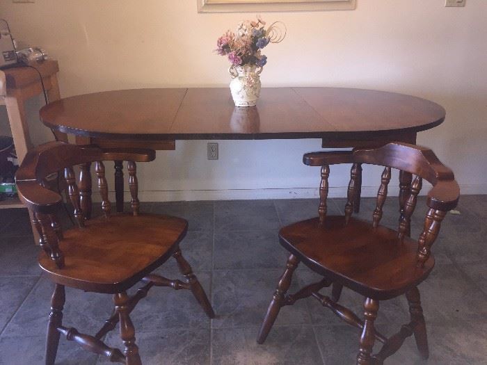  6' Oak table with two leaves (as shown) and 6 matching chairs (2 shown). We have 6 matching beautiful dark brown chair pads (not pictured)