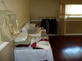 Some mens suits in the background and some linens