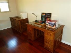 NIce wooden desk with a glass top that is solid, the file cabinets are solid wood too
