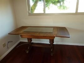 Here is the antique wooden table, the sides fold down, there is a small glass on top