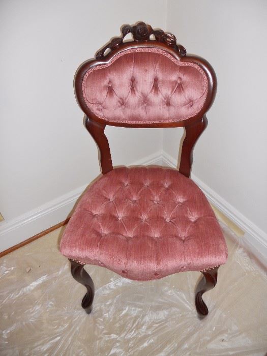 One of a set of carved and tufted Victorian chairs