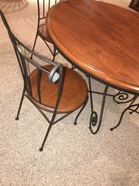 ROUND WOODEN TABLE WITH CAST IRON BASE AND FOUR CHAIRS