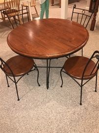 ROUND WOODEN TABLE WITH CAST IRON BASE AND FOUR CHAIRS