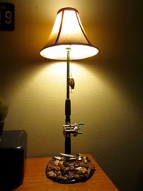Uniquely designed lamp for your man cave - features include:  turn the reel to turn/adjust light settings, hidden compartment under knife, Buffalo nickels & arrow heads on base 