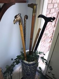 ANTIQUE BRASS AND WOOD WALKING CANES INSIDE TALL BLUE VASE