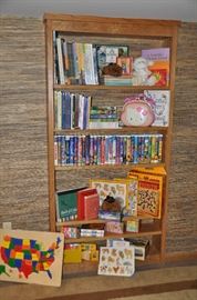 An assortment of new children's books and puzzles and vintage toys along with VHS Disney movies