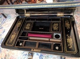 Black lacquer 'Japanned' sewing table with gilt floral scrolling, paw feet.
