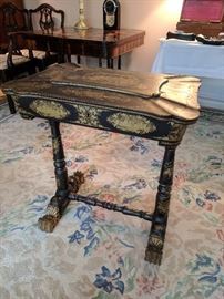 Black lacquer 'Japanned' sewing table with gilt floral scrolling, paw feet.
