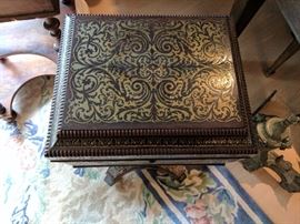 English Regency period coffer-form tea caddy on stand (or teapoy), hinged top above four canisters with brass scrollwork decorated (or Boulle-work) lids, quatrefoil base with casters.
