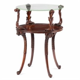 Carved Mahogany Glass Top Side Table: A mahogany glass top side table. This table has a circular glass top with etched ring borders, resting on carved acanthus brackets. Other features include splayed, cabriole legs with carved leaf knees and scrolled feet. It matches a coffee table with item number 17CIN224-454.