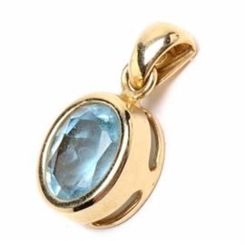 14K Yellow Gold Blue Topaz Pendant: A 14K yellow gold pendant featuring an oval blue topaz center gemstone.