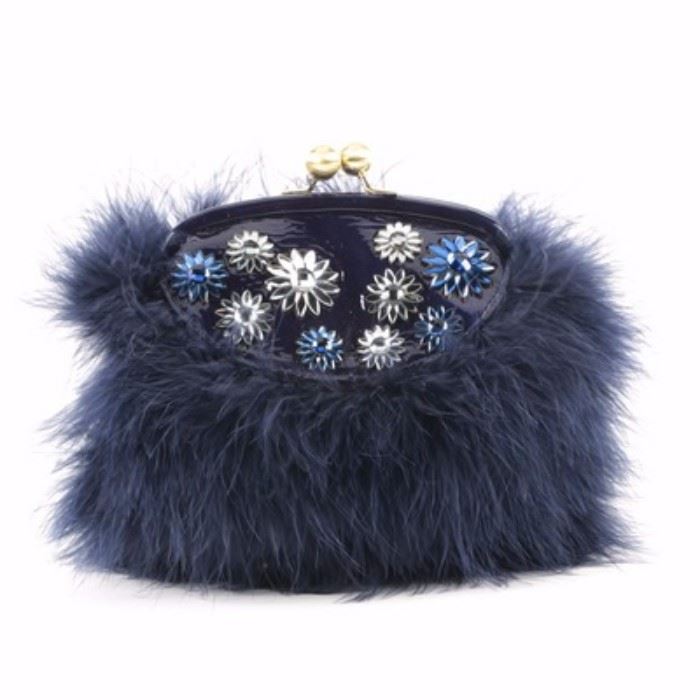Coach Poppy Jewel Frame Bag in Blue: A Coach Poppy Jewel frame bag in blue. This bag features an exterior covered in dyed blue feathers with a small spot on the top front of glass gem flowers on patent leather. This frame bag can be used as a clutch, a shoulder bag or a cross body using the chain attached. The hardware is gold tone and the interior is blue satin bearing the leather Coach creed in silver and marked with number “G1273-21321”.