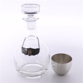 Decanter With Stieff Pewter Tag and Jefferson Cup: A decanter with Stieff Pewter tag and Jefferson cup. This collection of two items includes a glass decanter with around solid glass stopper and a Stieff Pewter tag that reads"Scotch". Also included in this collection is a Jefferson cup that reads “May 2nd 1978”.