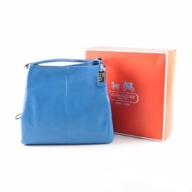 Coach Phoebe Bag and Matching Accessories in Cobalt Blue: A Coach cobalt blue leather Phoebe shoulder bag. This bag features a fine pebbled leather and double shoulder straps with silver tone branded hardware throughout. The three sections are finished with an ivory fabric lining, additional pocketing and a branded patch that reads, No. A1393-24621. An original branded storage box accompanies the piece.