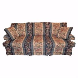 Floral Upholstered Sofa: A floral-upholstered sofa. This three-seat sofa is upholstered in a floral fabric. Also included are two throw pillows.