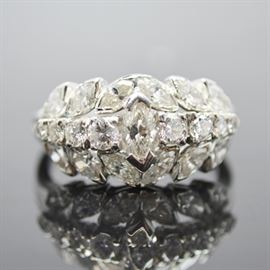 Platinum 2.29 CTW Diamond Ring: A platinum 2.29 ctw diamond ring. This ring features a center marquise diamond flanked by a row of graduated round diamonds and surrounded by other marquise cut diamonds.